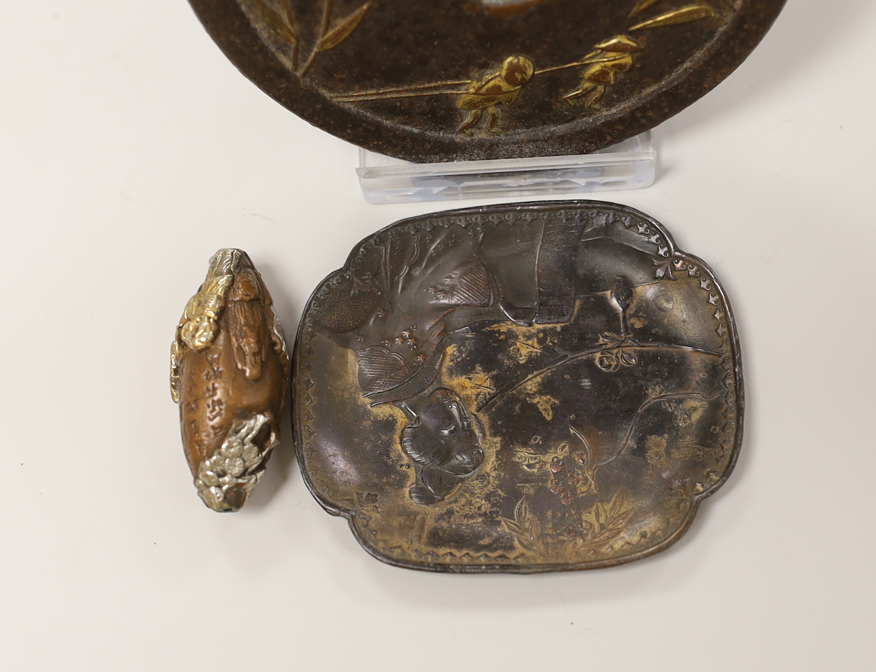 A gilt cast iron Japanese tsuba, gilt bronze ojime and pin dish